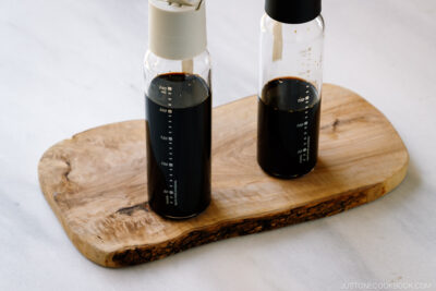 Two glass bottles containing smoked soy sauce.